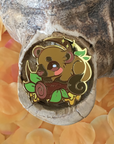 A hard enamel pin featuring the Kinkajou, alternatively called Honey Bear