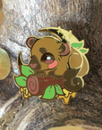 A hard enamel pin featuring the Kinkajou, alternatively called Honey Bear